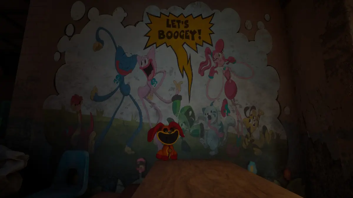A red Bobby BearHug plush beside monitors announcing a Zoomies factory event